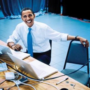 Barack Obama on the campaign trail, posing with Obama team's tool of choice, Apple Mac Laptops