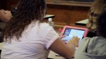girl taking notes with pink iPad